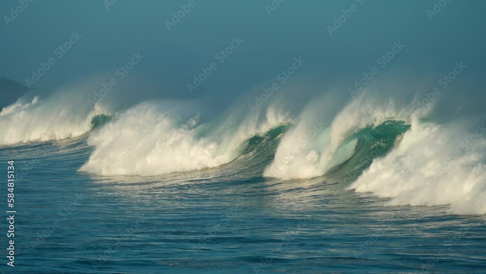 2022 - Tall blue waves roll towards Papohaku Beach, Hawaii.