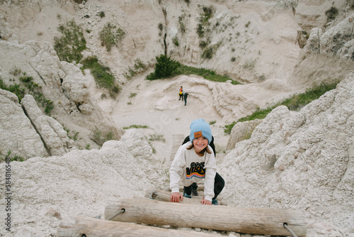 Kids climb staircase on Notch Trail hike in The Badlands National park