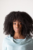Face of a young African girl with piercing in her nose and afro hairstyle