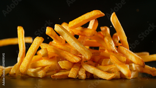 Tablou canvas Freeze Motion Shot of Falling Fresh French Fries, Close-up