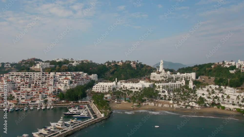 Manzanillo, Mexico - 11.21.2022 Aerial view of Peninsula de Santiago in city Manzanillo, Mexico. Beautiful bitch and luxury hotels and boat and yacht berth Manzanillo, Mexico - 11.21.2022 Aerial view of Peninsula de Santiago in city Manzanillo, Mexico. Beautiful bitch and luxury hotels and boat and yacht berth
