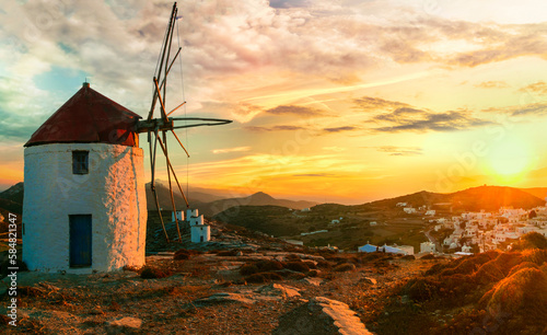 Traditional typical greek windmills. Amorgos island in Cyclades, view of Chora village over sunset