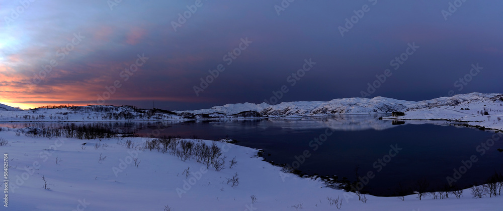 landscape sunset in snowy nature and sea in tromso