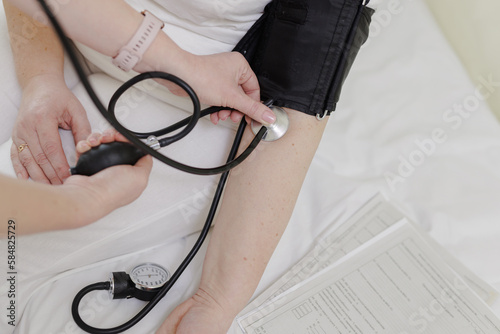 doctor measures the pulse of a patient in a hospital