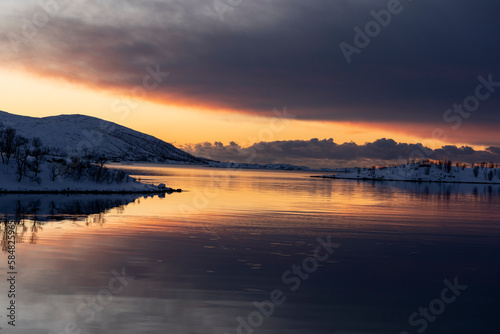 landscape sunset in snowy nature and sea in tromso