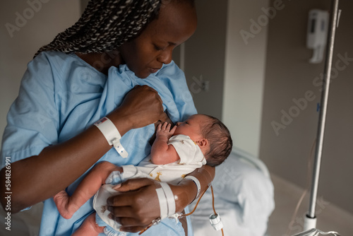 Black mom breastfeeding baby in hospital photo