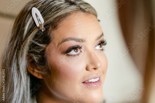 Closeup of Bride as She Gets Her Makeup Done photo