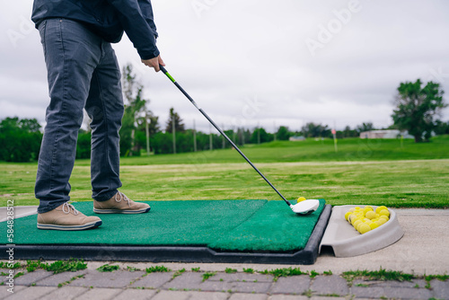 man playing golf. golf ball on lip of cup