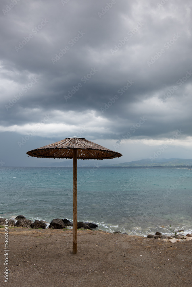 Beach umbrellas at a rocky coast in winter. Summer vacations Beach umbrellas at a rocky coast in winter. Summer vacations