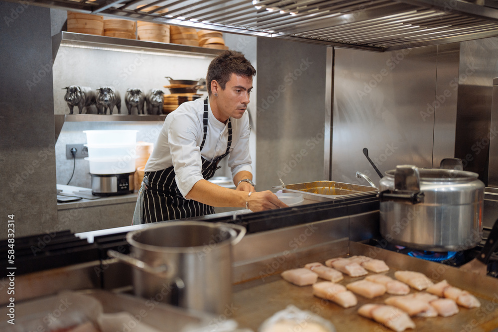 Man working in restaurant kitchen Man working in restaurant kitchen