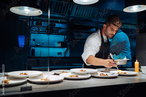 Chef doing plating at night photo