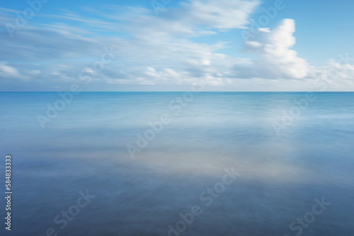 Blue smooth sea water with sky