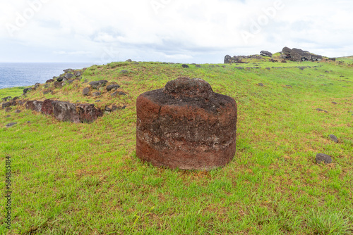 A Pukao with petroglyphs in Vinapu on Easter Island (Rapa Nui), Chile -2023. The pukao is an ornament, made of red scoria from the crater of Puna Pau which was placed on the head of the statues. 