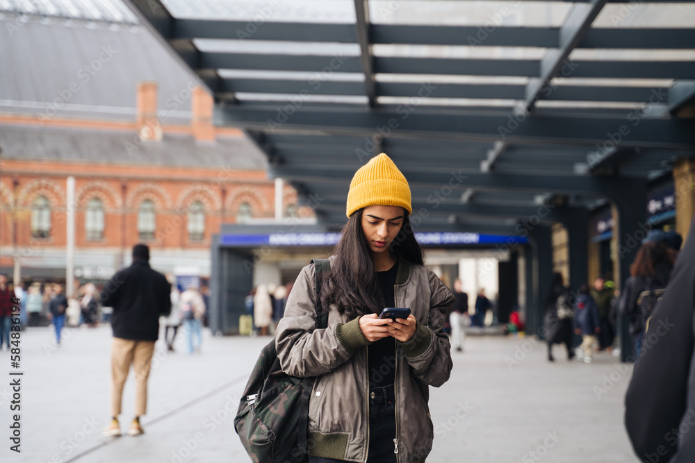 © Hernandez & Sorokina/Stocksy - Woman Using Phone On The Street © Hernandez & Sorokina/Stocksy - Woman Using Phone On The Street