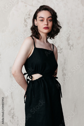 Elegant French style woman with red lips  in black dress in studio