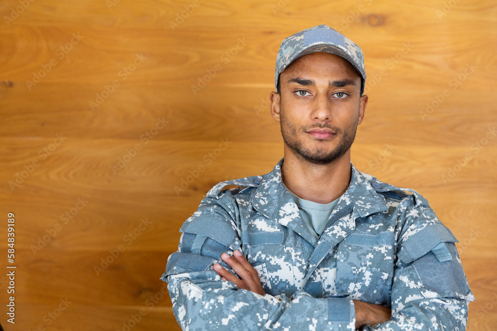 Portrait of biracial male soldier wearing military uniform and cap, looking at camera, copy space Portrait of biracial male soldier wearing military uniform and cap, looking at camera, copy space