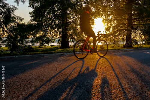 Cyclist riding through a sunset