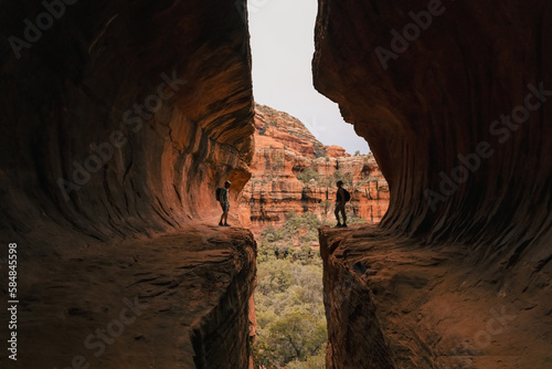 Young couple stands opposite each other in Subway Cave Boynton Canyon.