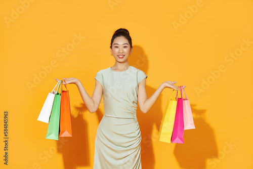 Fullbody of Asian beautiful happy young woman with shopping bags photo