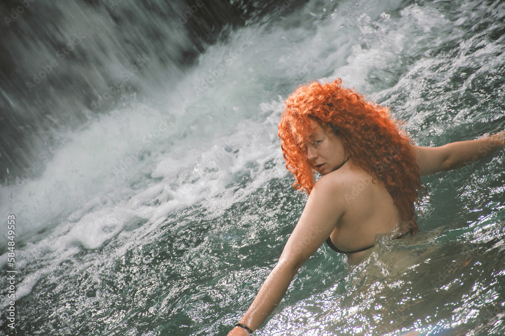 Curly red hair woman on water Curly red hair woman on water
