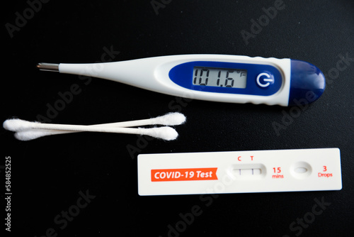 COVID-19 and flu pandemics such as a thermometer, syringe, cotton swab, inhaler, medicine pills, and an empty medication ampule. photo