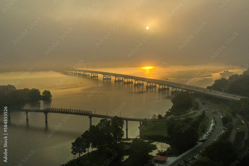 Fototapeta premium A colorful bridge meandering through the fog 