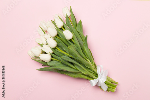 White tulip bouquet on color background  top view