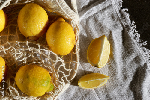 Fototapeta Naklejka Na Ścianę i Meble -  fresh lemons in cotton eco string bag