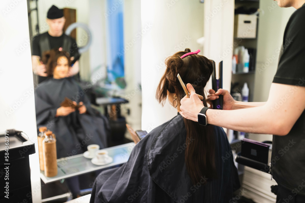 Hairdresser working on woman's hair Hairdresser working on woman's hair