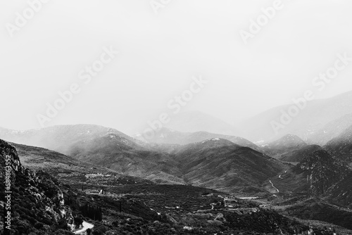 Majestic mountains, mountain slope covered with greenery. Dramatic, moody landscape, journey. The cloud envelops the top of the mountain, contrast black white, mist mountains.