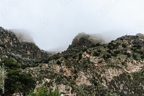 Majestic mountains, mountain slope covered with greenery. Dramatic, moody landscape, travel journey.