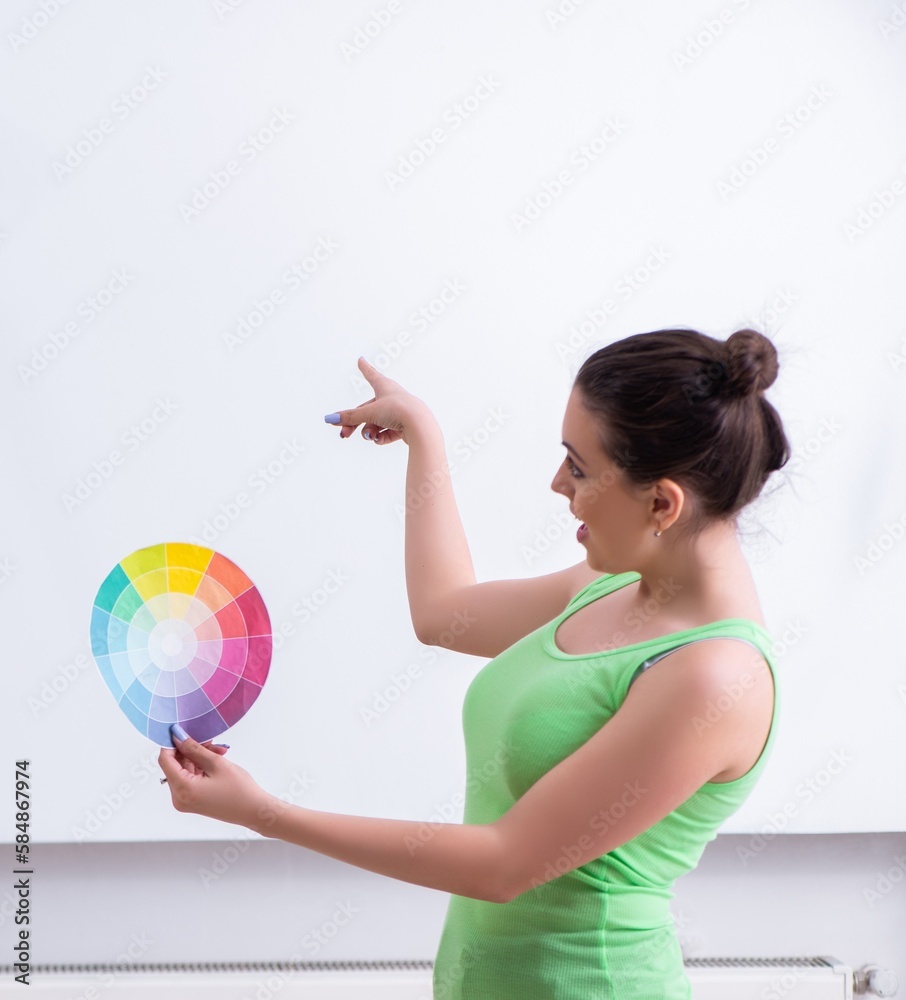 Young beautiful woman doing renovation at home Young beautiful woman doing renovation at home