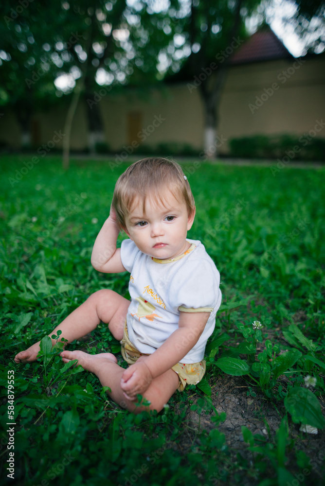 Portrait of a little boy sitting on the grass Portrait of a little boy sitting on the grass