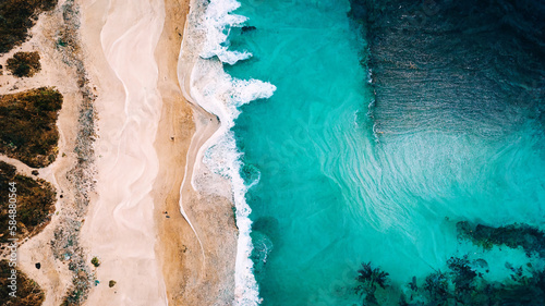 Waves breaking on beach, aerial drone nature landscape from above