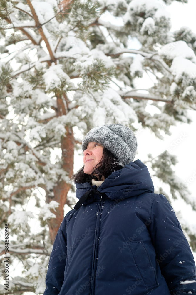 A woman walking in the winter forest A woman walking in the winter forest