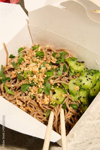 Soba noodle salad dish from food truck cart in to-go packaging.  photo