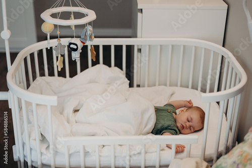 Cute newborn baby sleeping in cradle photo