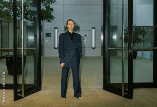 Androgyne woman wearing man classic suite  indoors