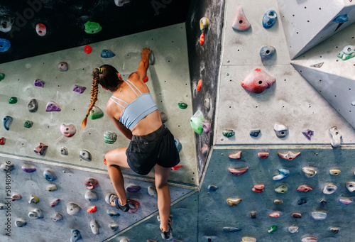 Woman climber on climbing wall
