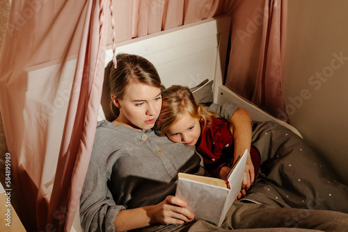 Mother and daughter reading fairy tale 