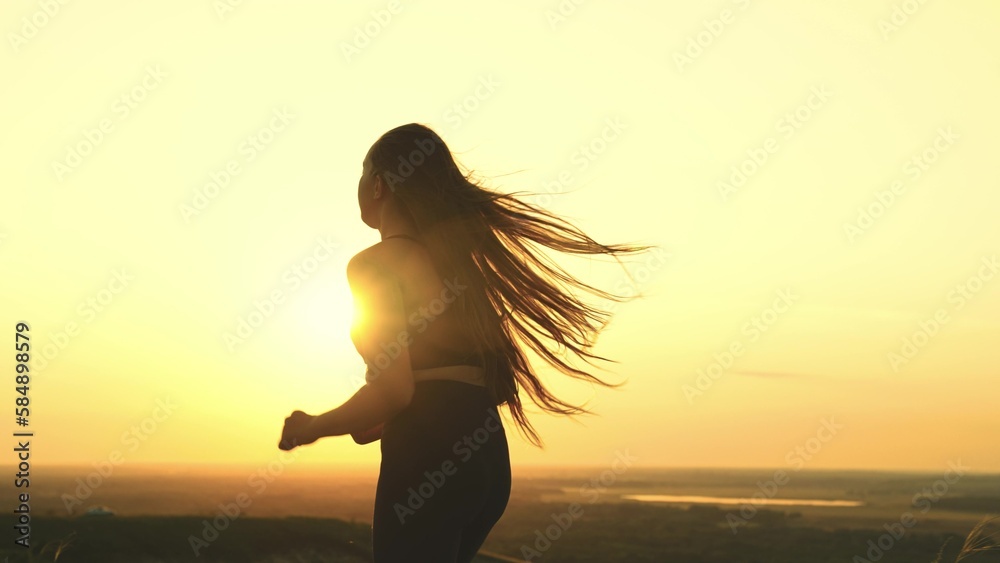 young beautiful girl runs sunset. jogging sunset. athletic man sun with his hair disheveled wind. women dream beautiful body. sports running evening outdoors. relax jogging morning dawn nature.