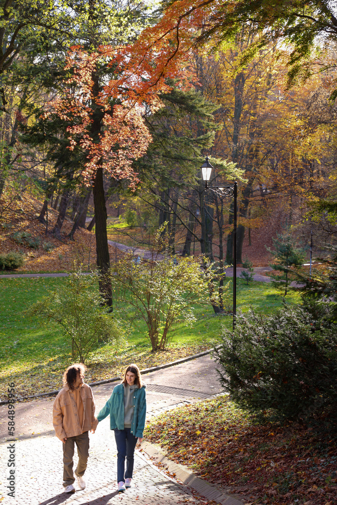 Happy young couple walking in autumn park. Dating agency Happy young couple walking in autumn park. Dating agency