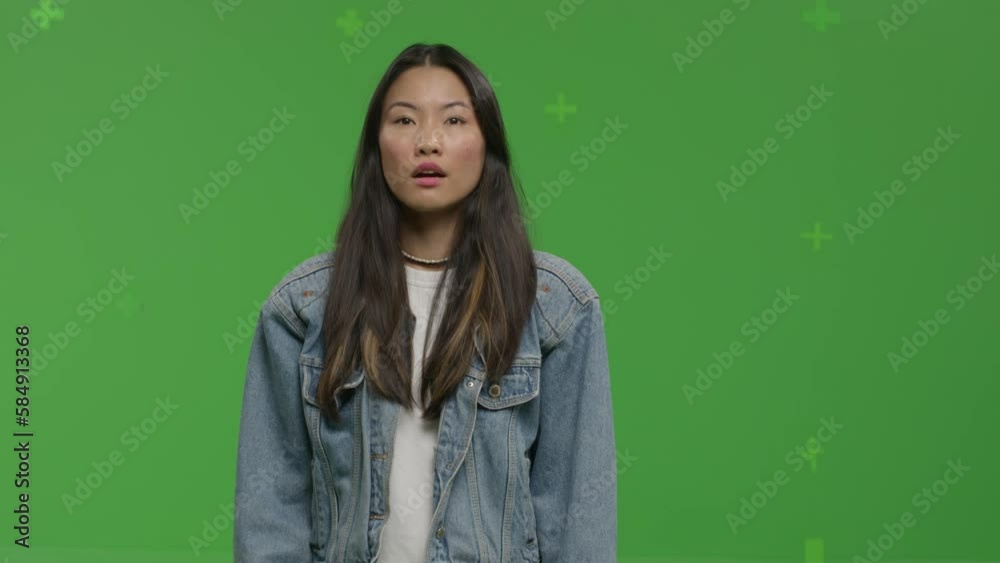 GREEN SCREEN CHROMA KEY CU Portrait of 20s Asian female student pretending she is visiting art exhibition GREEN SCREEN CHROMA KEY CU Portrait of 20s Asian female student pretending she is visiting art exhibition