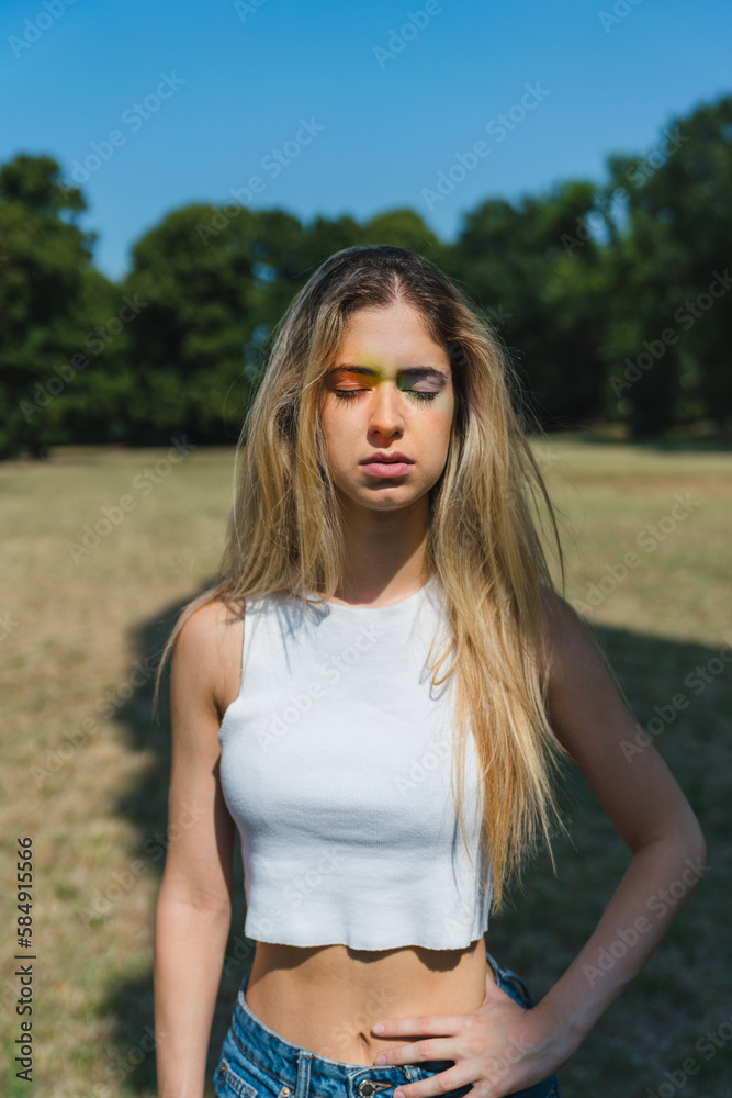 Blonde Young Woman with a Colored Rainbow Prism on her Face Blonde Young Woman with a Colored Rainbow Prism on her Face