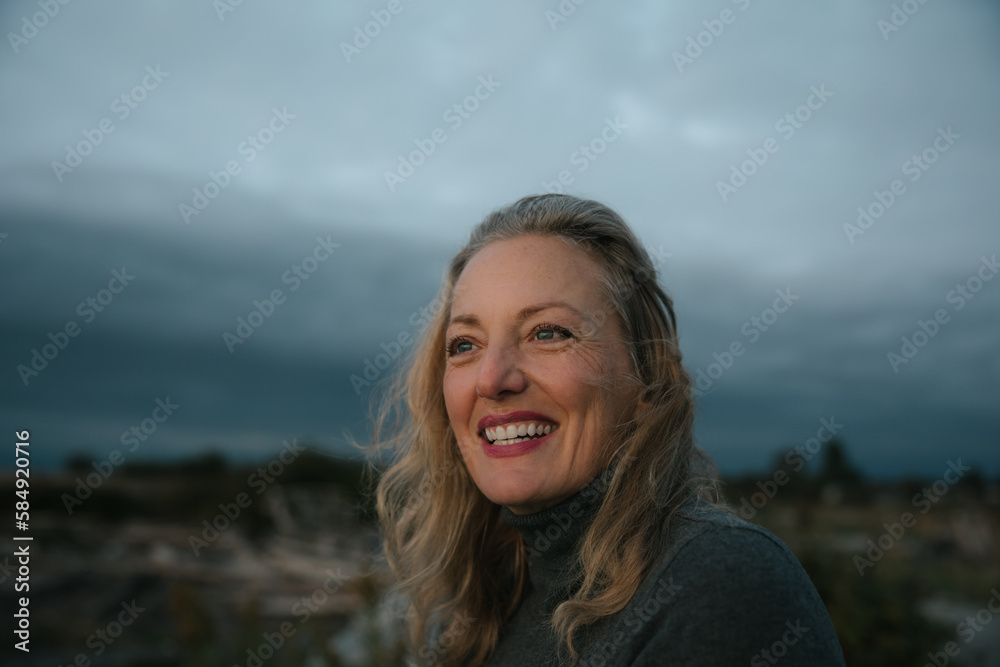 Healthy mature woman looking up at the sky for sunset portrait. Healthy mature woman looking up at the sky for sunset portrait.