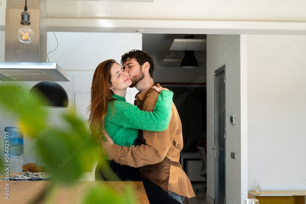 Couple hugging at kitchen Couple hugging at kitchen