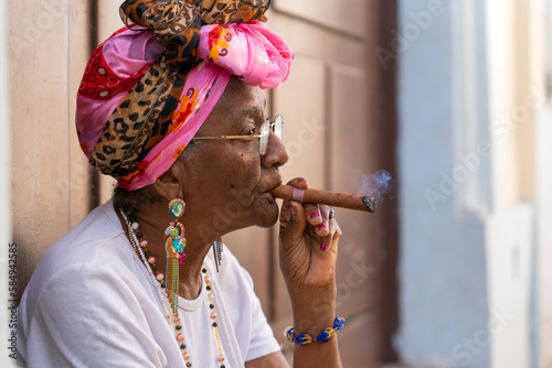 Black Woman Smoking A Cigar In Cuba. photo