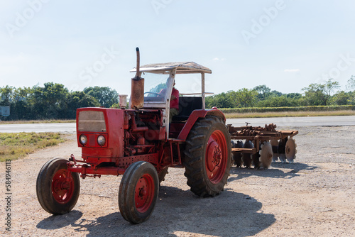 Man Driving A Red Old Tractor