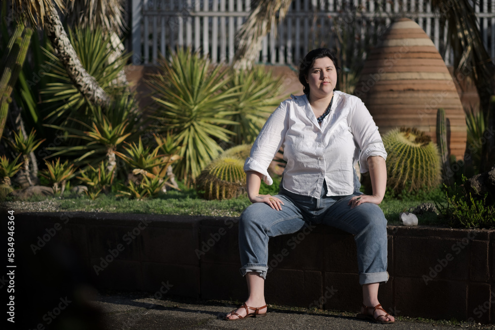 A black-haired White woman at the park A black-haired White woman at the park
