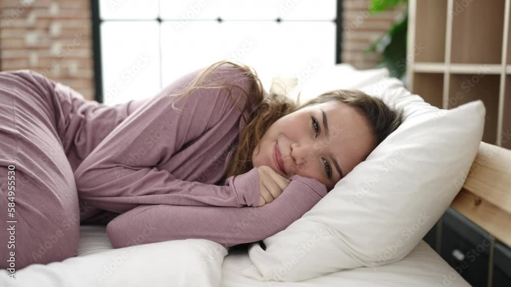 Young beautiful hispanic woman smiling confident lying on bed at bedroom Young beautiful hispanic woman smiling confident lying on bed at bedroom